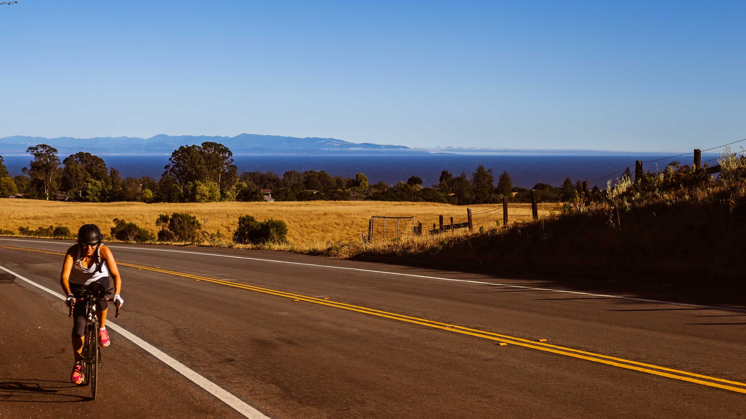 Yamila Miguel riding her road bike at golden hour